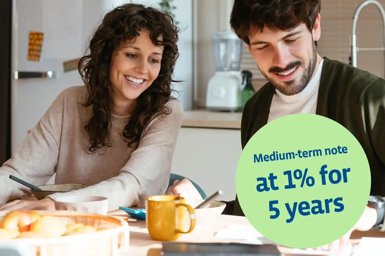 Man and woman at the breakfast table going through documents