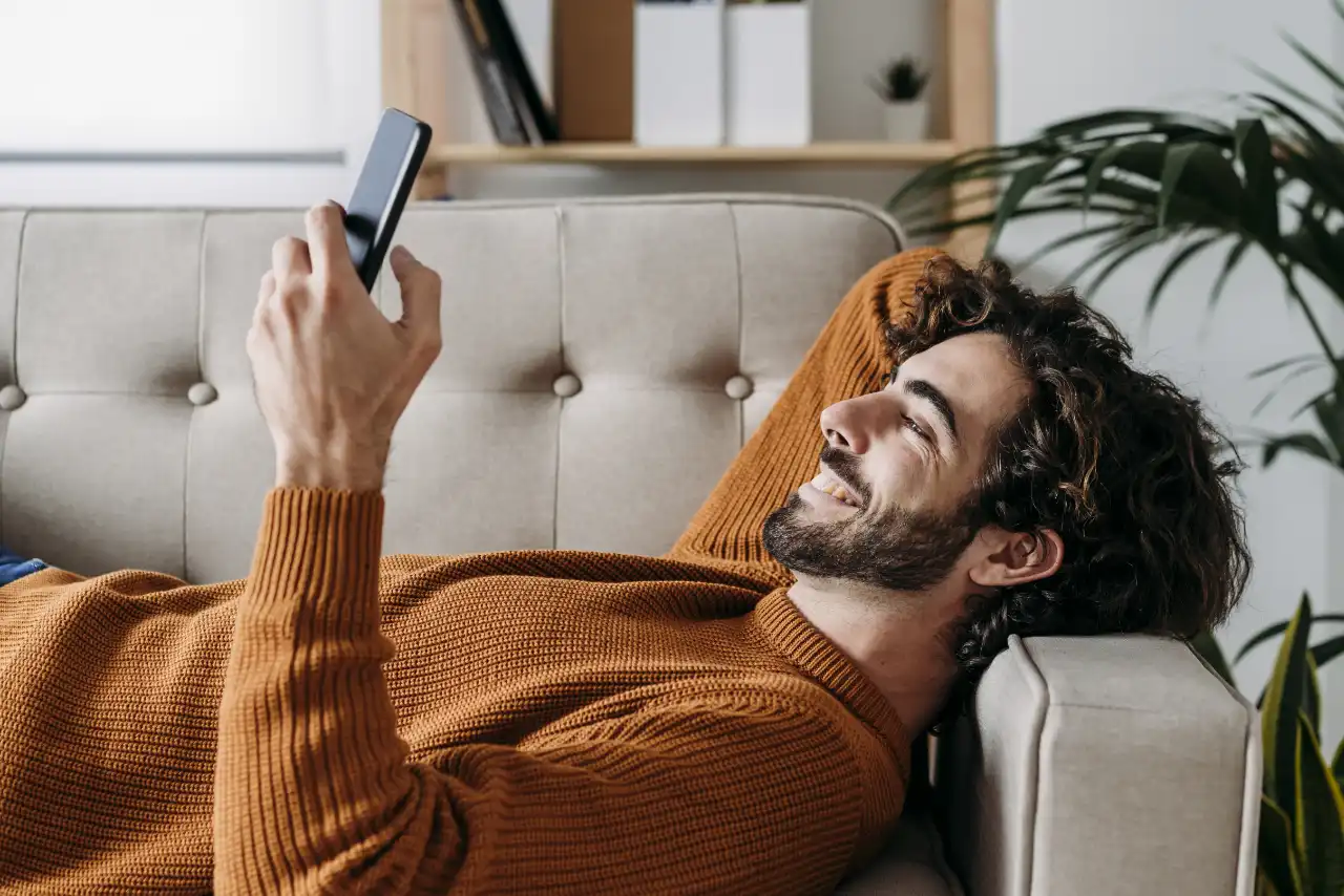 Man with mobile phone on the sofa
